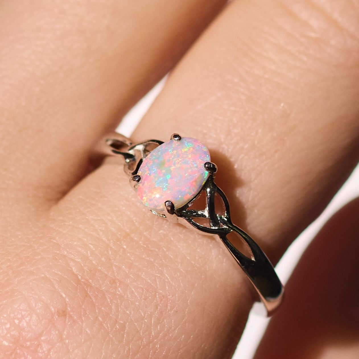 semi black opal ring elegant engagement design sterling silver claw ring, red, and soft pink stone colours